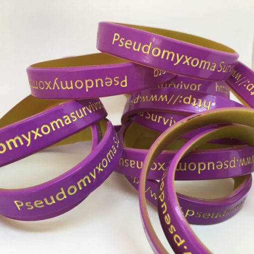 a photo of a pile of Pseudomyxoma Survivor wristbands
